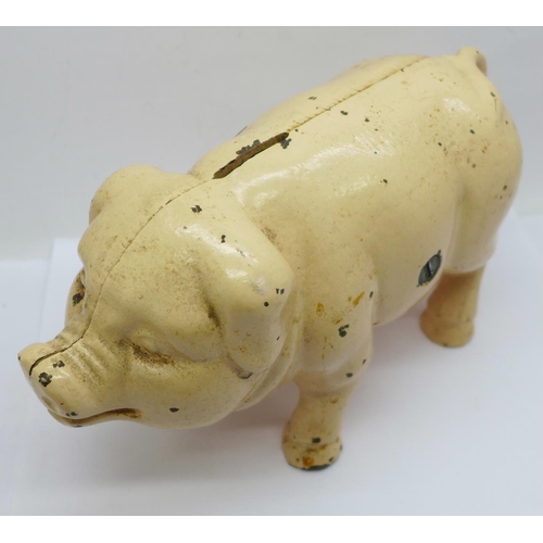 657 - A metal money box in the form of a pig, 21cm