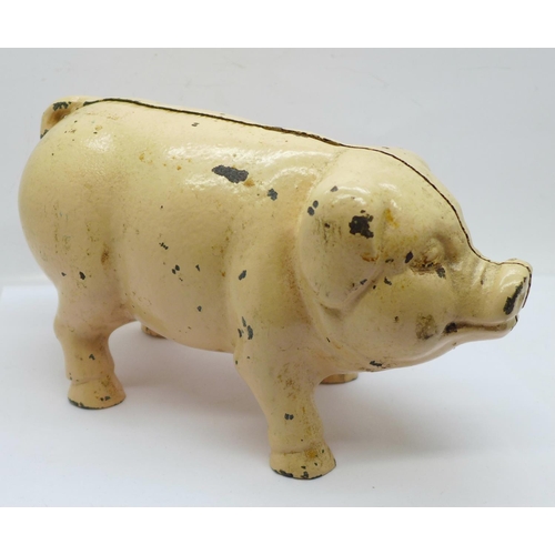 657 - A metal money box in the form of a pig, 21cm