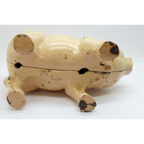 657 - A metal money box in the form of a pig, 21cm