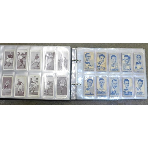 693 - Two albums of football related cigarette cards