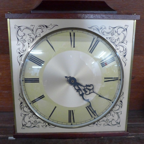 725 - A wall clock and three mantel clocks