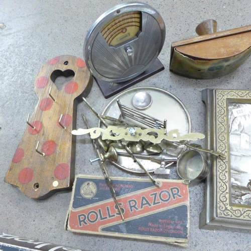 764 - A box of assorted items, framed 19th Century tile, blotter, etc.