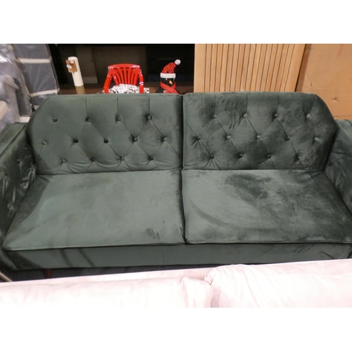 3070 - A green velvet three seater sofa with adjustable, fold down back * this lot is subject to VAT