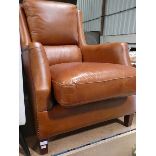 3077 - A Nubuck tan leather armchair * this lot is subject to VAT