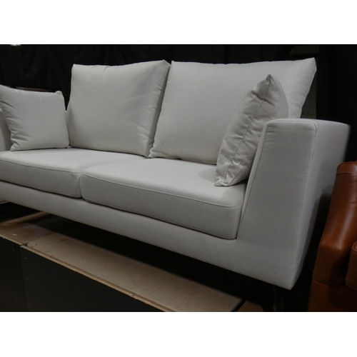 3078 - A cream fabric upholstered three seater sofa * this lot is subject to VAT