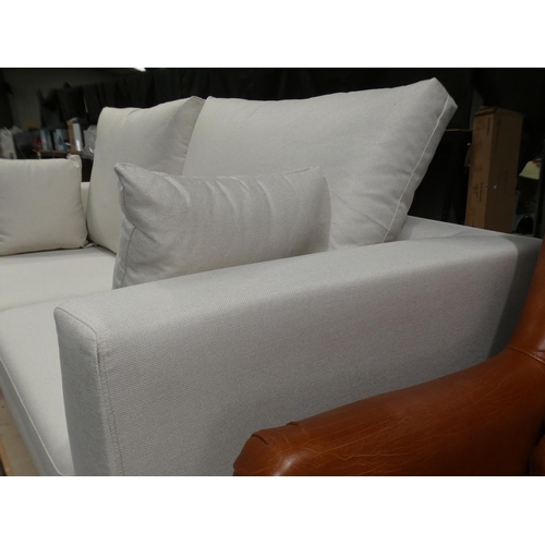 3078 - A cream fabric upholstered three seater sofa * this lot is subject to VAT