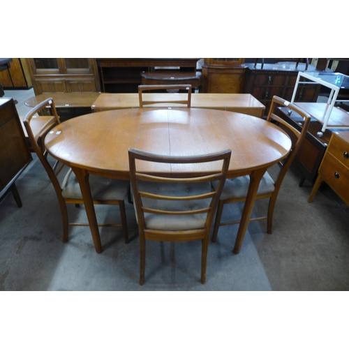 104 - A teak extending dining table and four chairs