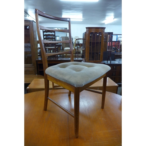 104 - A teak extending dining table and four chairs