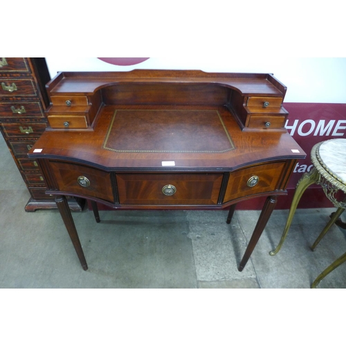 17 - An inlaid mahogany and leather topped writing desk