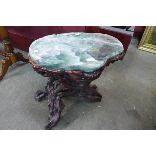 21 - A Chinese green hardstone occasional table, on naturalistic root wood stand