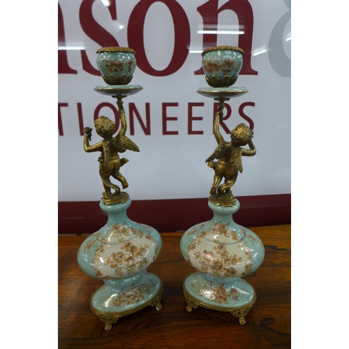 26 - A pair of French style turquoise porcelain and gilt metal figural cherub candlesticks