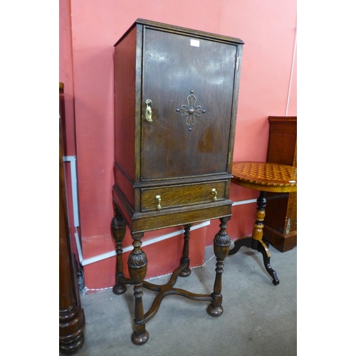 31 - A 17th Century style carved oak cabinet on stand