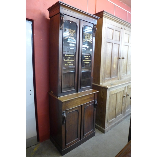 32 - A Victorian mahogany bookcase, bearing later Dunn & Co. Hat Makers, London inscription to doors