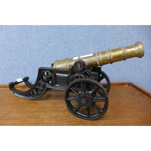 396 - A cast iron and brass miniature cannon