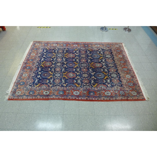 47 - A large blue ground geometric patterned rug, approx. 300 x 210cms