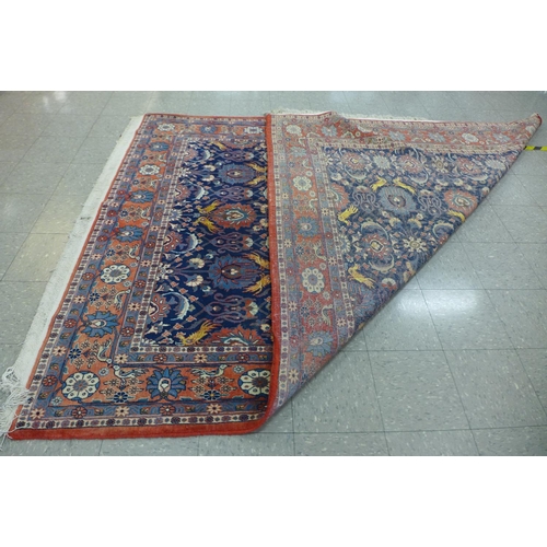 47 - A large blue ground geometric patterned rug, approx. 300 x 210cms