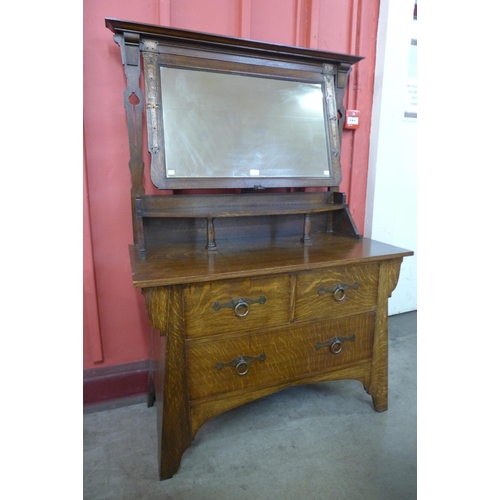 8 - An Arts and Crafts oak and copper mounted dressing chest, manner of Liberty & Co.