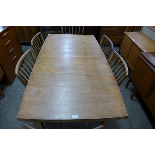 93 - A teak extending dining table and six chairs