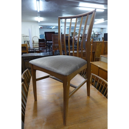 93 - A teak extending dining table and six chairs