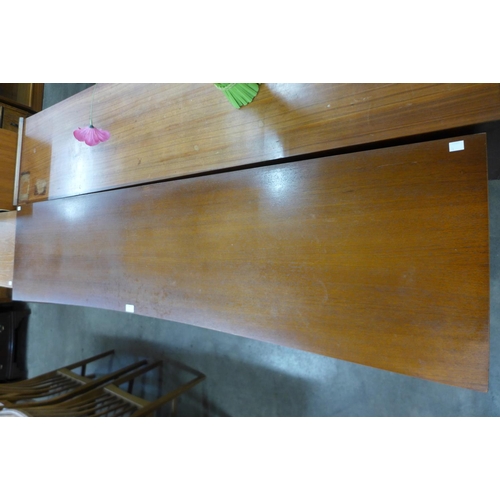 94 - A teak concave sideboard