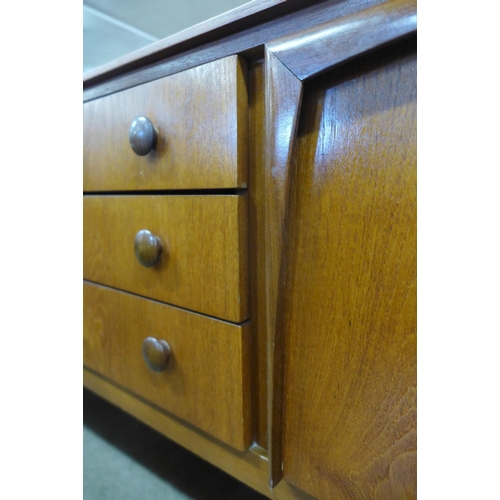 94 - A teak concave sideboard