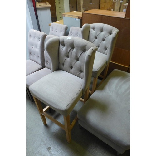 1729 - A pair of sand upholstered wingback bar stools