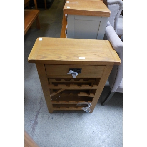 1730 - A rustic oak wine cabinet - damaged * this lot is subject to VAT