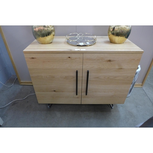 1320 - A Valentino industrial oak small two door sideboard * this lot is subject to VAT