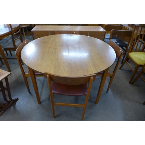 599 - A teak extending dining table and four chairs