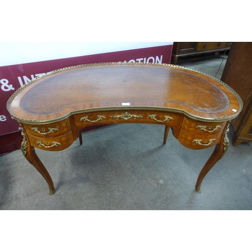 30 - A French Louis XV style parquetry inlaid kingwood and ormolu mounted kidney shaped writing table