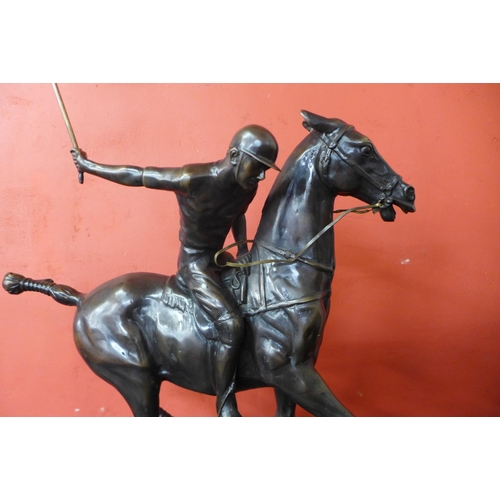 37 - A large bronze figure of a polo player on horse, on black marble plinth