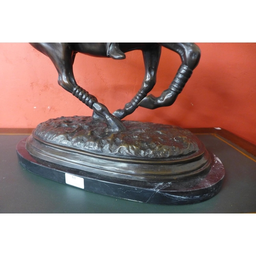 37 - A large bronze figure of a polo player on horse, on black marble plinth