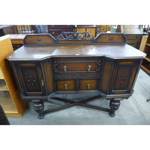 110 - A carved oak sideboard