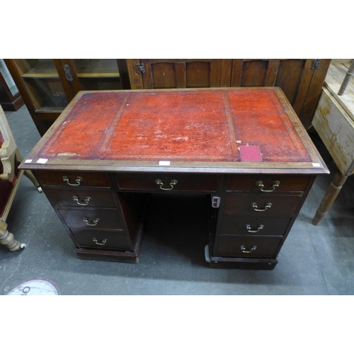 132 - A Victorian oak and red leather topped desk