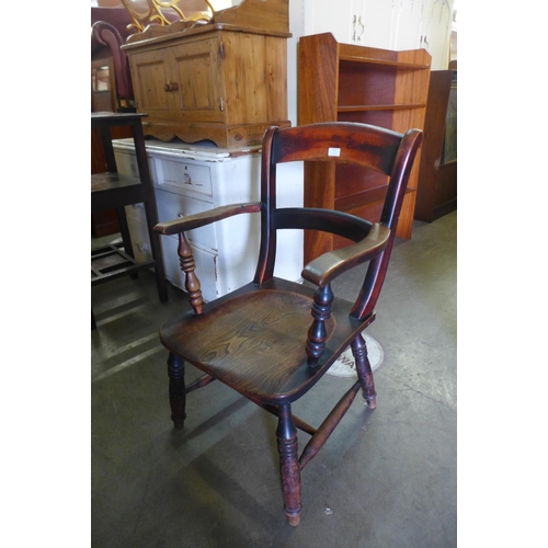 134 - A Victorian elm and beech elbow chair