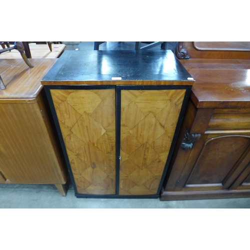 159 - An Art Deco ebonised and satin birch music cabinet