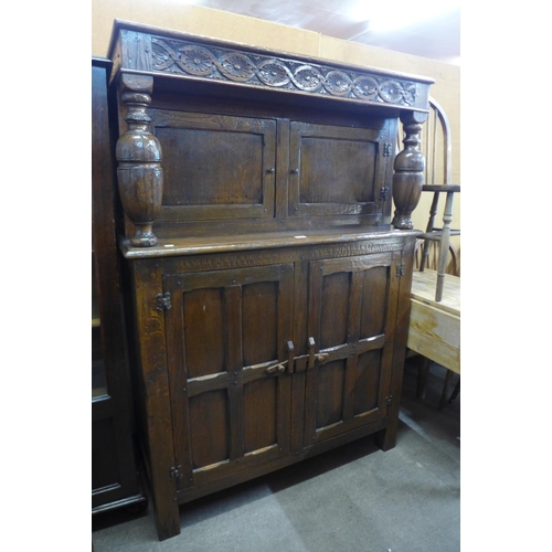 173 - A carved Ipswich oak court cupboard