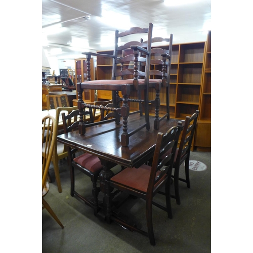 180 - An oak draw-leaf refectory table and six chairs