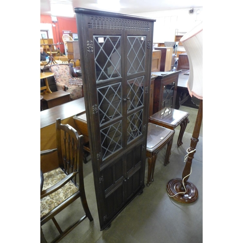 183 - An oak extending dining table, six chairs and a corner cabinet