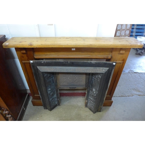 225 - A cast iron fire surround with beech chimney-piece