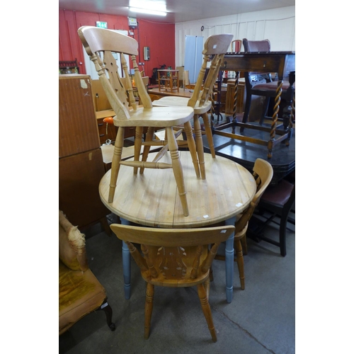 236 - A pine circular kitchen table and four beech chairs