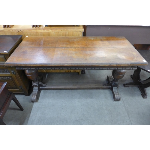 138 - An oak extending refectory table and four chairs