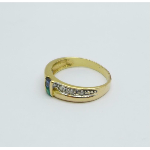 1004 - A yellow metal ring set with blue, green and white stones, control marks on the outside of the shank... 