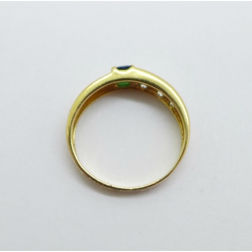 1004 - A yellow metal ring set with blue, green and white stones, control marks on the outside of the shank... 