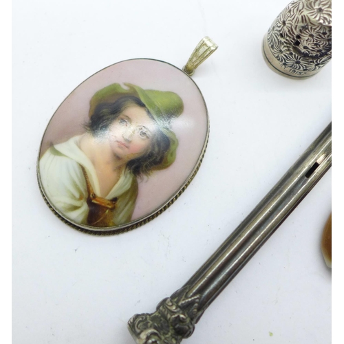 1029 - A silver mounted portrait pendant, a novelty compass mounted shell, a hallmarked silver thimble, a/f... 