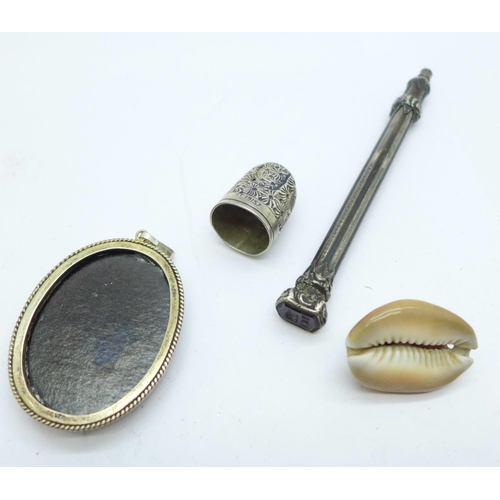 1029 - A silver mounted portrait pendant, a novelty compass mounted shell, a hallmarked silver thimble, a/f... 