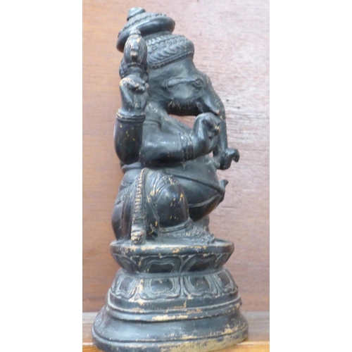 620 - A carved wooden figure of a sitting Ganesh, 35cm