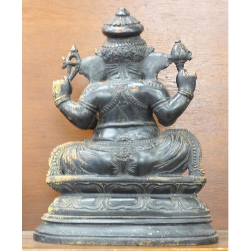 620 - A carved wooden figure of a sitting Ganesh, 35cm