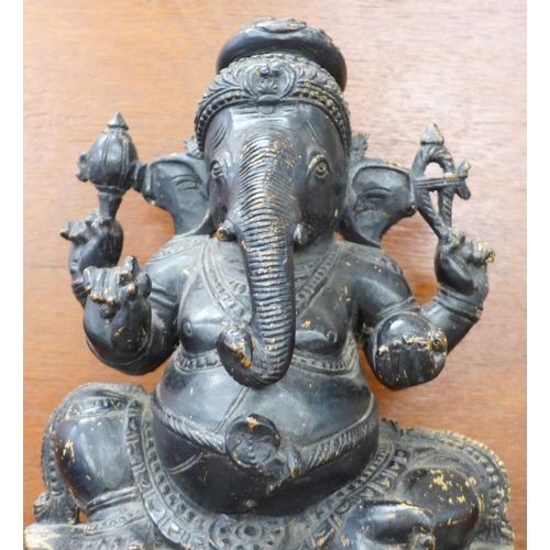 620 - A carved wooden figure of a sitting Ganesh, 35cm