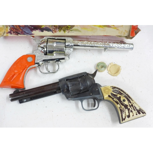 723 - A Crescent Toys Rustler '45' six chamber repeater cap gun, boxed, and one other model pistol